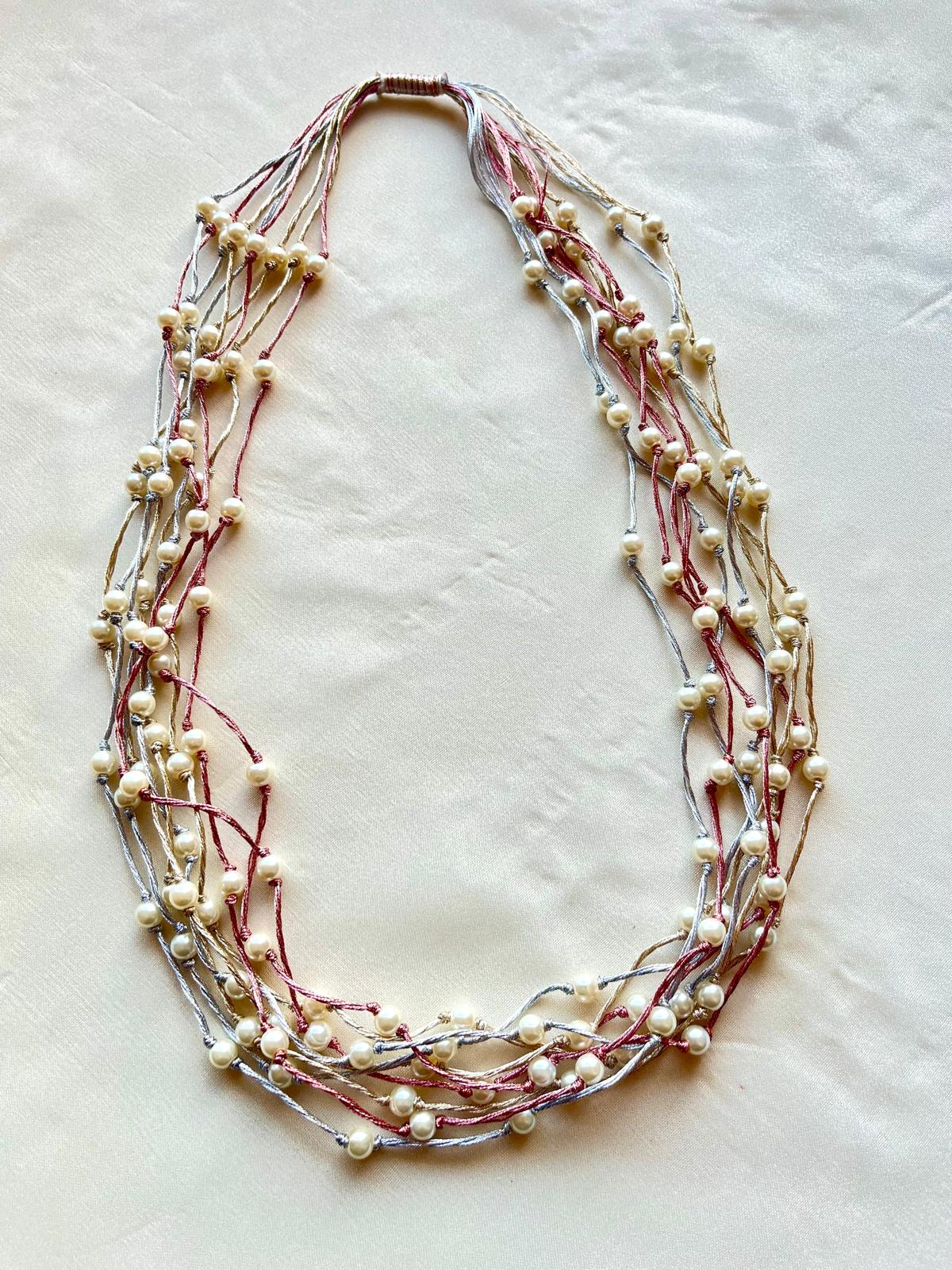 Pretty Necklace of White Pearls & Silver Gold & Rose Satin threads.hand knotted tightly.